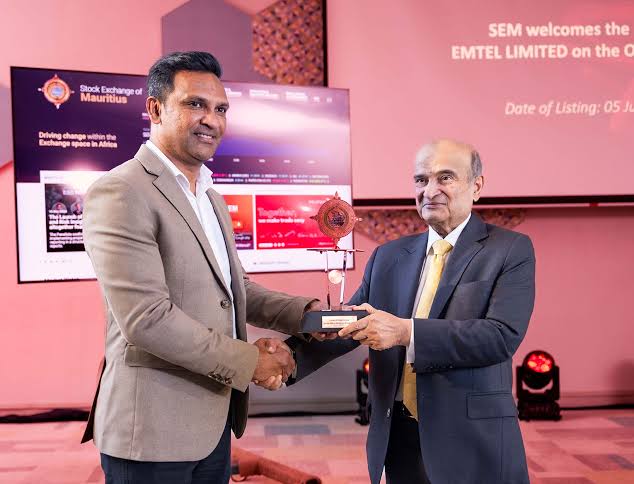 Bashirali Currimjee receiving a commemorative trophy at the Stock Exchange of Mauritius listing ceremony for Emtel Limited